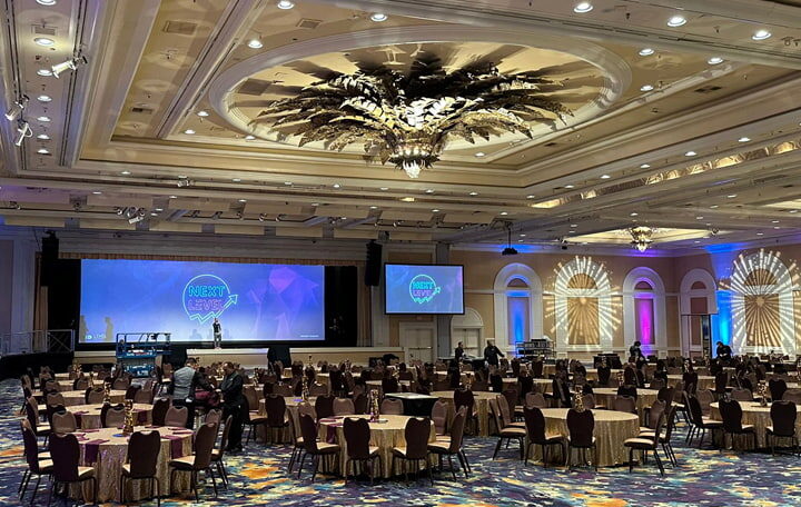 Next level conference room, with a screen and chairs and tables
