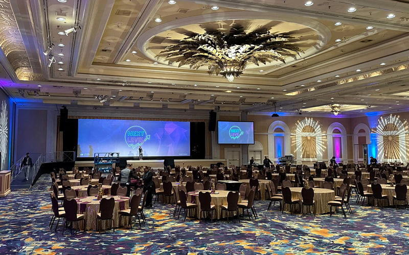 Next level conference room, with a screen and chairs and tables
