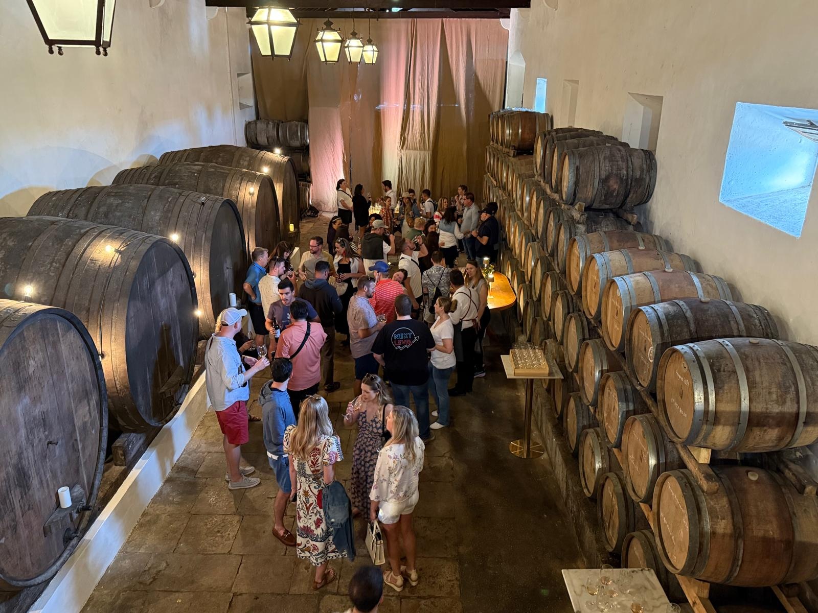 A group of people stood between barrels