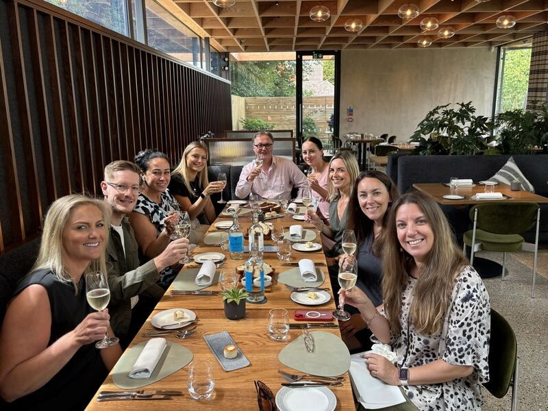 Team all sat around a dinner table