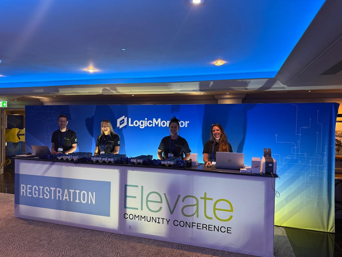 Four people behind a table at event